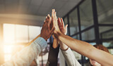 We always win. Shot of a group of colleagues giving each other a high five.