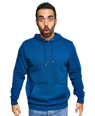 Sticker - Young hispanic man wearing casual clothes scared and amazed with open mouth for surprise, disbelief face