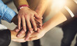 © Donson/peopleimages.com - Were united as a team. Shot of a group of people putting their hands together.