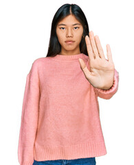 Sticker - Beautiful young asian woman wearing casual winter sweater doing stop sing with palm of the hand. warning expression with negative and serious gesture on the face.