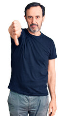 Sticker - Middle age handsome man wearing casual t-shirt looking unhappy and angry showing rejection and negative with thumbs down gesture. bad expression.