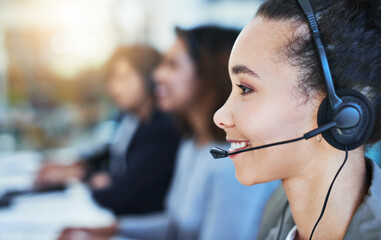 Wall Mural - allow me to direct your call. shot of a young woman working in a call centre.