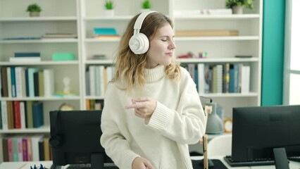 Sticker - Young blonde woman student smiling confident listening to music at library university