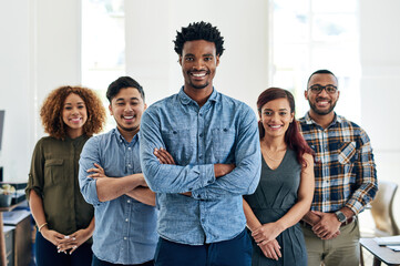 Leinwandbilder - Doing what we love and loving what we do. Portrait of a team of happy and confident colleagues working in a modern office.