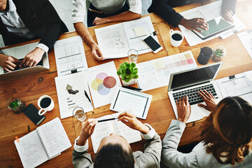 Poster - Unpacking it all. High angle shot of a group of businesspeople having a meeting in an office.