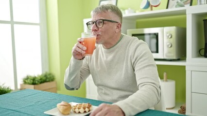 Poster - Middle age grey-haired man having breakfast sitting on table at home