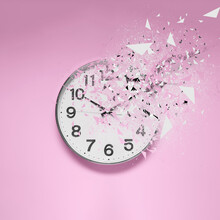 Fleeting Time Concept. Analog Clock Dissolving On Pink Background
