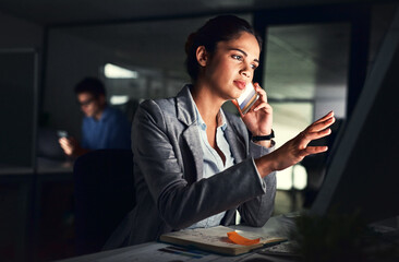 Leinwandbilder - Success is built on hard work. Cropped shot of a young attractive businesswoman working late at night in the office.