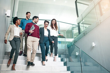 Aufkleber - The end of another successful business day. Shot of a group of colleagues talking together while walking down stairs in a large modern office.