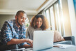 © Donson/peopleimages.com - Managing money matters with wireless technology. Shot of a young couple using a laptop while working on their home finances.