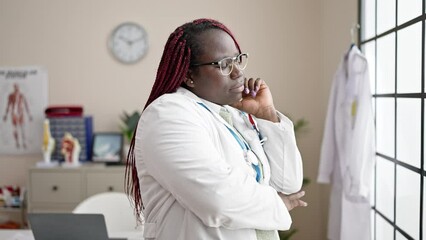 Sticker - African woman with braided hair doctor looking though the window standing at clinic