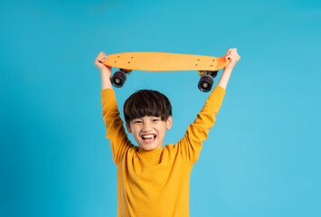 Asian boy portrait posing on blue background