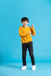 © Q88 - full body image of asian boy posing on blue background