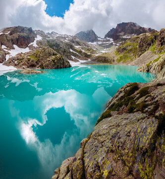 Wall Mural - Fantastic alpine lake Lac Blanc surrounded by mountains in summer. Graian Alps, France, Europe.