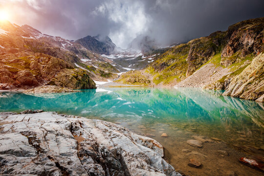 Wall Mural - Fantastic alpine lake Lac Blanc surrounded by mountains in summer. Graian Alps, France, Europe.