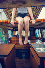 A Young Woman Hangs Out In A Retro Camper Van.