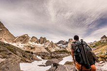 Backpacker Hiking Into Mountains Of The Wind River Range With Gear.