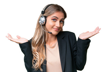 Wall Mural - Telemarketer pretty Uruguayan woman working with a headset over isolated background having doubts while raising hands