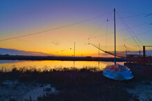 Sunset Over The Marsh, With An Old Boat On The Right