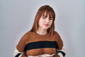 Sticker - Young beautiful woman wearing striped sweater over isolated background with hand on stomach because indigestion, painful illness feeling unwell. ache concept.