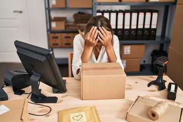 Wall Mural - Young hispanic woman ecommerce business stressed leaning on package at office