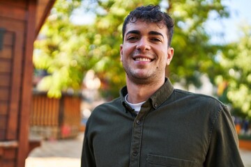 Canvas Print - Young hispanic man smiling confident standing at park