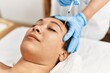 © Krakenimages.com - Young hispanic woman having antiaging treatment at beauty center
