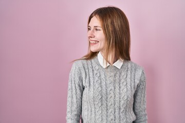 Sticker - Beautiful woman standing over pink background looking away to side with smile on face, natural expression. laughing confident.