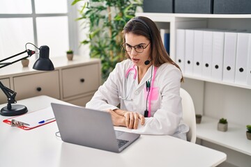 Poster - Beautiful doctor woman working on online appointment scared and amazed with open mouth for surprise, disbelief face