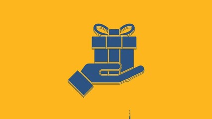 Wall Mural - Blue Gift box in hand icon isolated on orange background. Merry Christmas and Happy New Year. 4K Video motion graphic animation