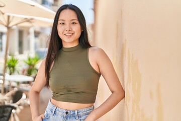 Poster - Young chinese woman smiling confident standing at street