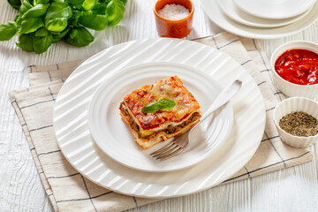 Wall Mural - portion of Lasagna on white plate, top view