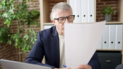 Poster - Middle age grey-haired man business worker stressed reading document at office