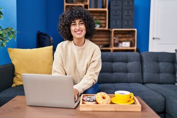 Sticker - Young middle east woman using laptop having breakfast at home