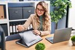 © Krakenimages.com - Young woman business worker holding document on folder at office
