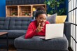 © Krakenimages.com - Young african american with braids working using computer laptop smiling happy pointing with hand and finger to the side