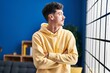 © Krakenimages.com - Young caucasian man standing with arms crossed gesture at home