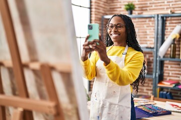 Wall Mural - African american woman artist make picture by the smartphone to draw at art studio