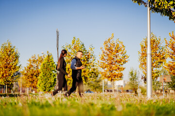 Couple hanging out in the park on a sunny day