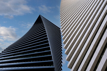 Close-up beautiful geometric background of two modern high-rise buildings side by side