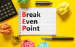 BEP break even point symbol. Concept words BEP break even point on white note on a beautiful yellow background. Black pen. Calculator. Business and BEP break even point concept. Copy space.