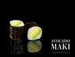 Side view of Maki sushi roll pieces with mirror reflection on black background. Sushi roll with avocado and nori seaweed on top. Ready menu advertising banner with text and copy space.