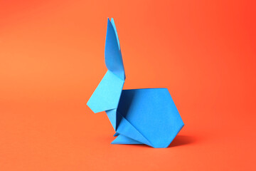 Sticker - Origami art. Beautiful paper rabbit on orange background