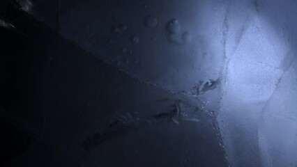 Wall Mural - Abstract ice background. Blue background with cracks on the ice surface.