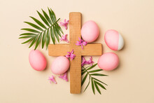 Pink Easter Eggs With Cross And Palm Leaves On Color Background, Top View