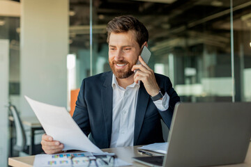 corporate communication. happy male manager working remotely, reading financial document and talking