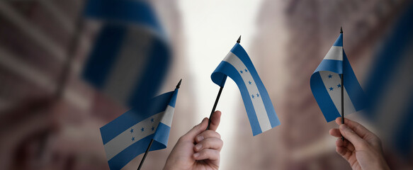 Wall Mural - A group of people holding small flags of the Honduras in their hands