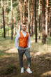 © omelnickiy - portrait of the groom in a gray suit and an orange vest