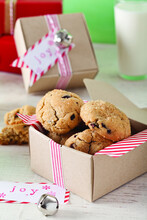 High Angle View Of Chocolate Chip Cookies In Cardboard Box On Wooden Table At Home