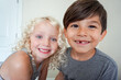 © Cavan Images - boy and girl staring at camera closeup smiling